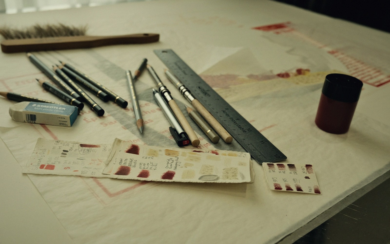 a course designer's paper plan on a table, pencil and ruler